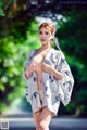 A woman in a kimono is posing for the camera.