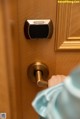 A person is opening a door with a smart lock.