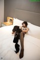 A woman laying on a bed in a hotel room.