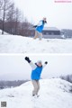 A man standing on top of a snow covered hill.