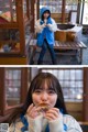 A woman in a blue jacket eating a piece of food.