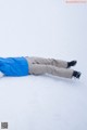 A person laying in the snow with their feet up.