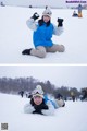 A woman laying on the ground in the snow.