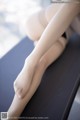 A close up of a woman's legs on a table.