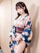 A woman in a kimono posing for a picture.